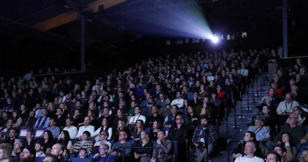 People sit in a movie theater