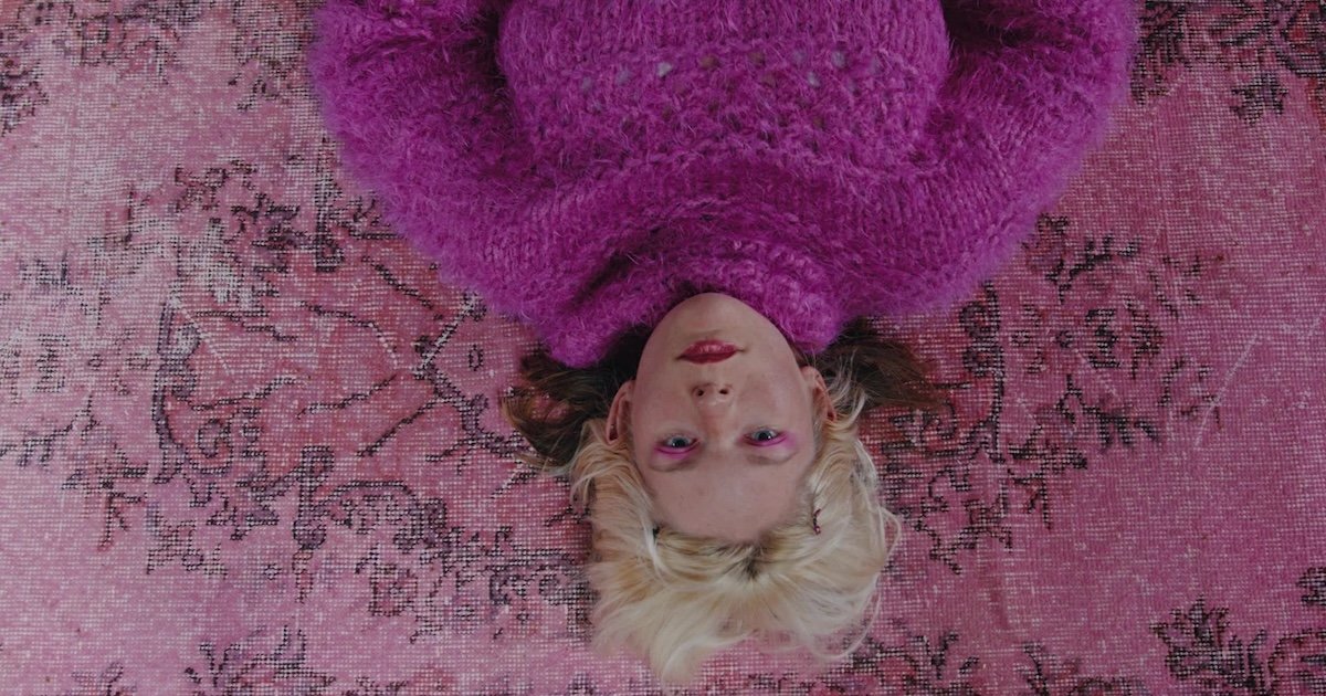 A person lays on the carpet