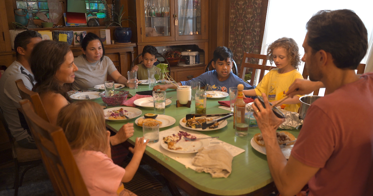 A family sits around a table in a scene from "Good Help"