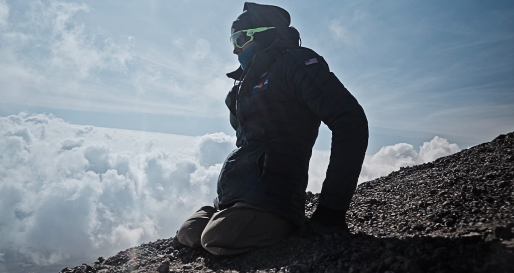 The subject of "The Ascent" on a mountain