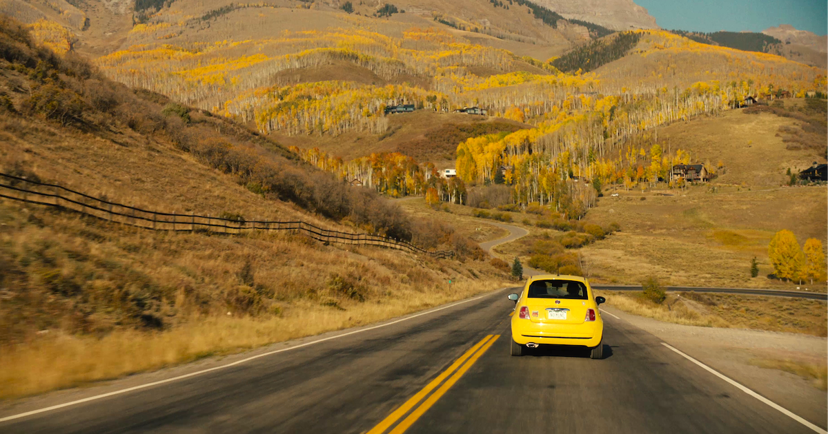 A shot of a car driving in Colorado during the film Welcome to the Fishbowl